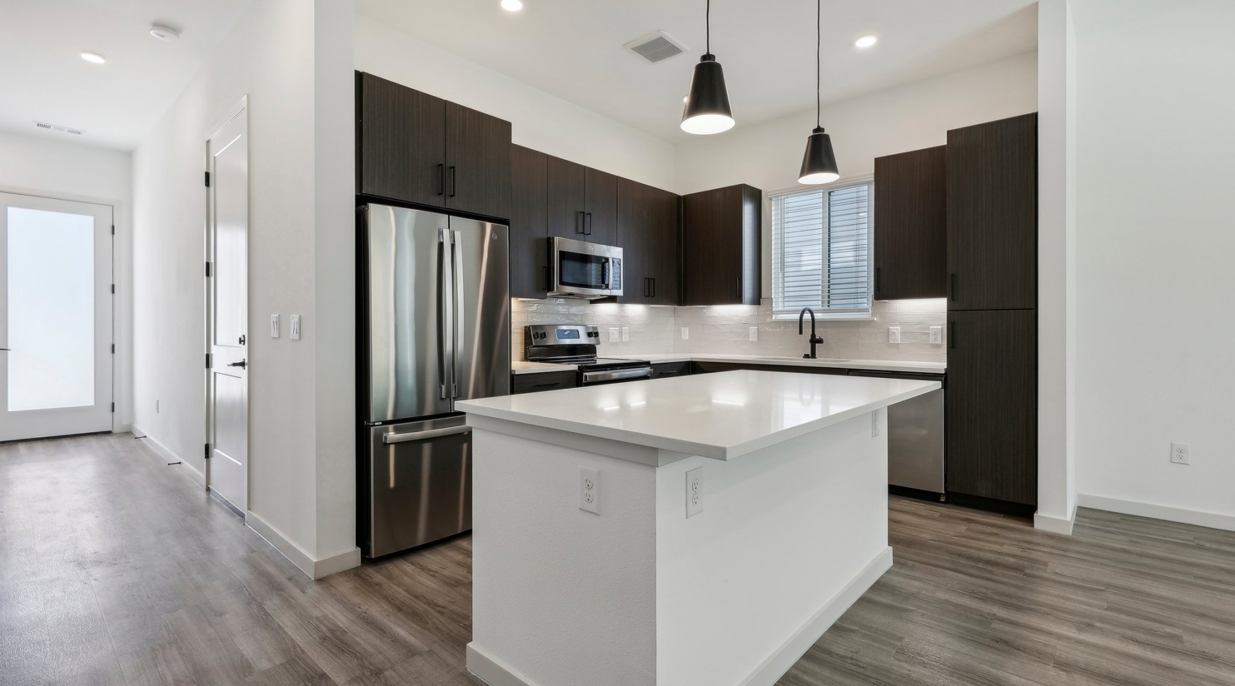 Kitchen with large island and stainless steel appliances Kitchen with large island and stainless steel appliances